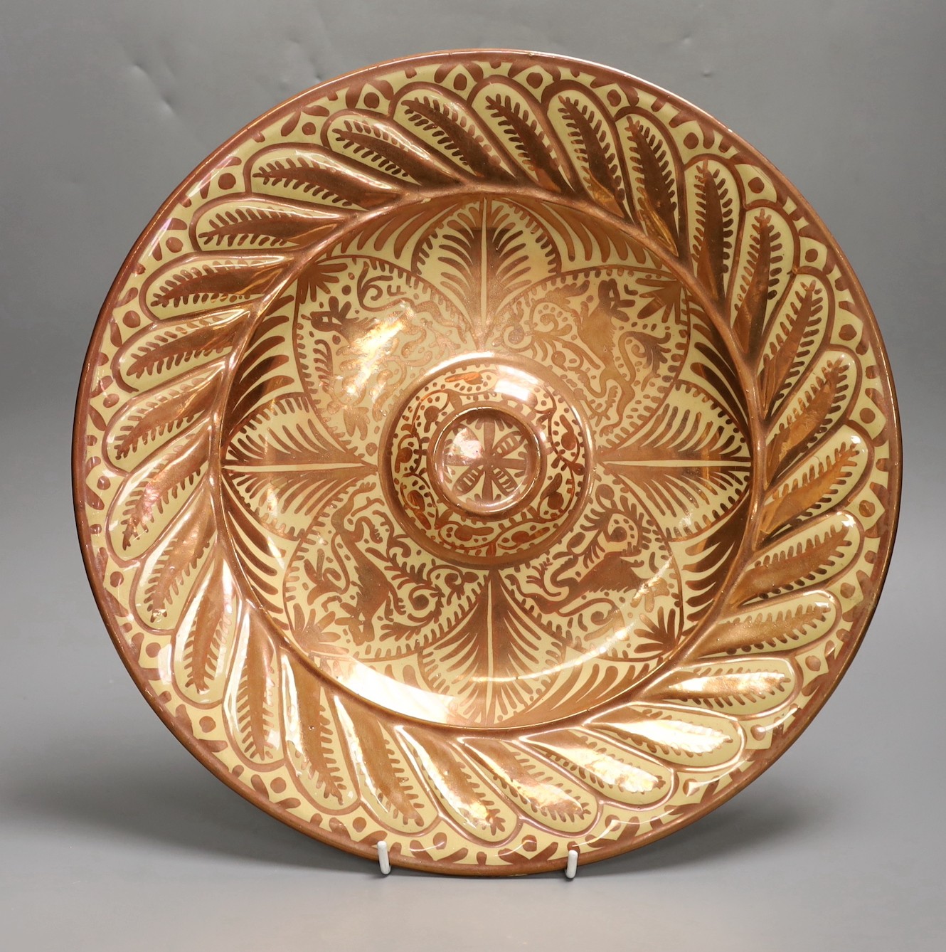 A Hispano Moresque style copper lustre pottery charger and vase, 24cm tall